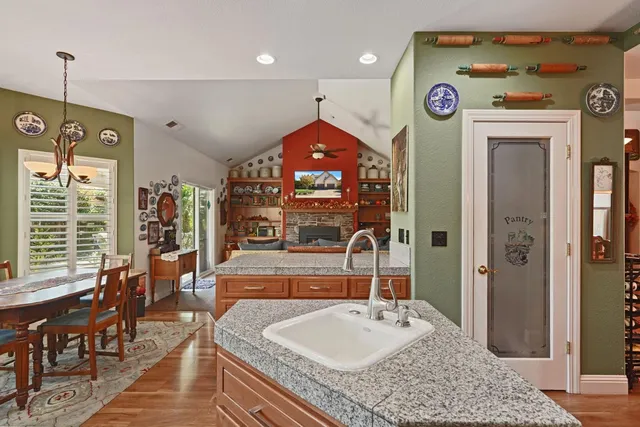 a living room with furniture a fireplace and a large window