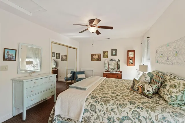 a patio with table and chairs and potted plants