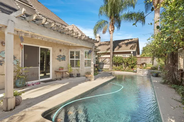 an aerial view of a house with a yard and mountain view in back