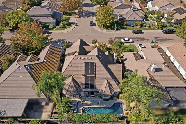 an aerial view of a house with a yard