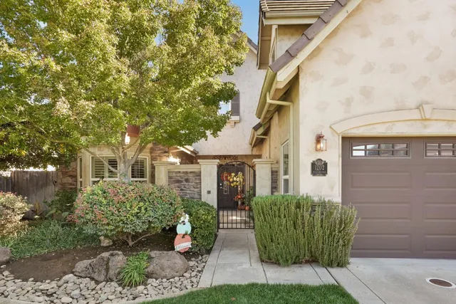 a front view of a house with garden