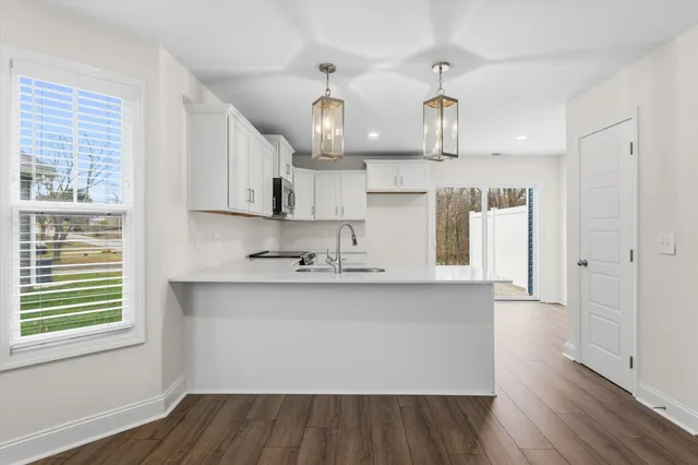 a kitchen with kitchen island stainless steel appliances a sink and cabinets