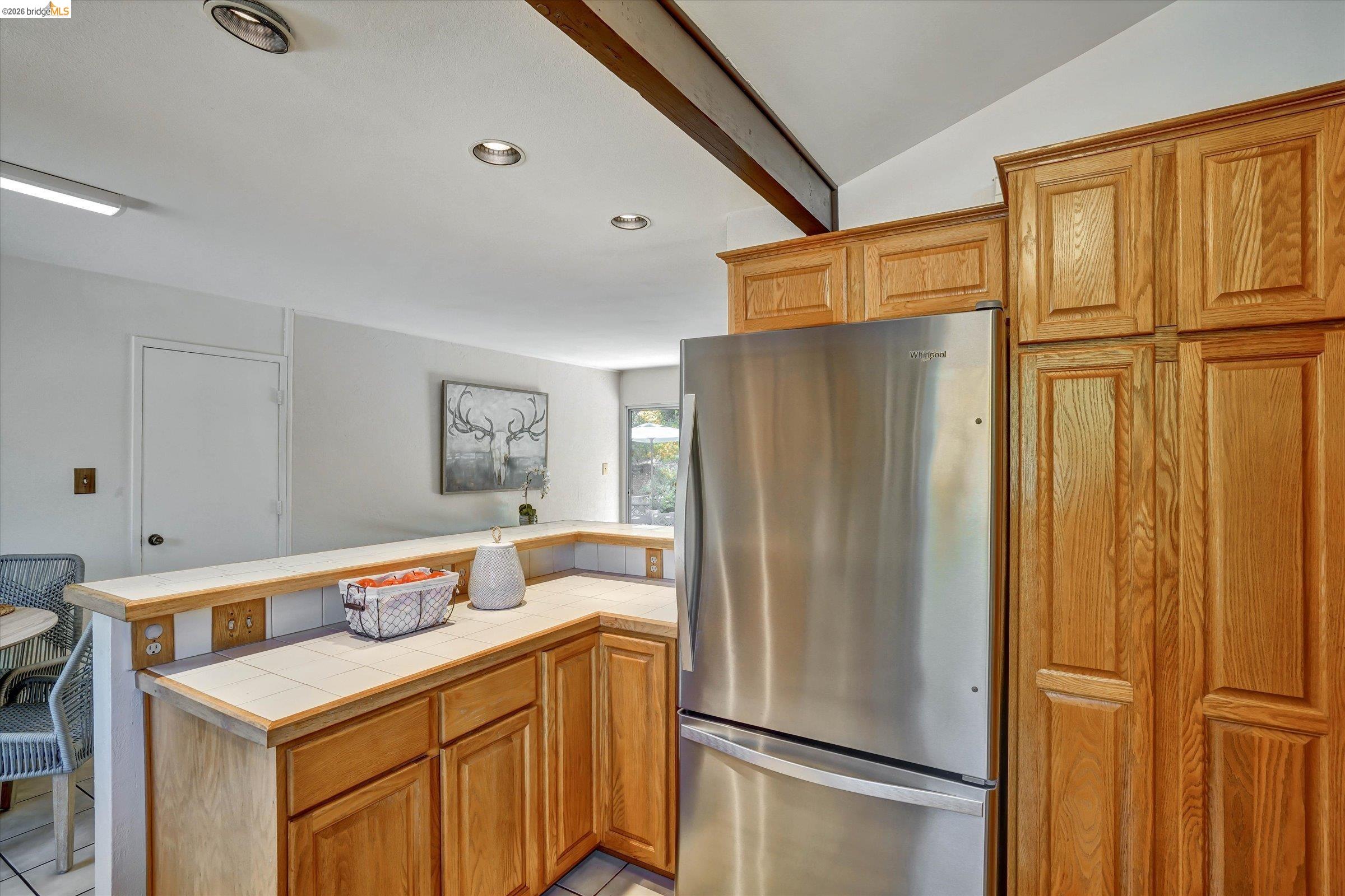2826 Wright Avenue Pinole, CA 94564 - Photo 21 of 70 Kitchen featuring a stainless steel refrigerator, light wood cabinetry, tile countertops, and a white ceiling with recessed lighting