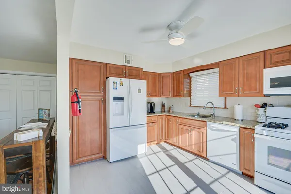 a kitchen with stainless steel appliances a refrigerator sink and cabinets