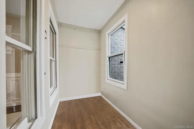 a view of an entryway with wooden floor