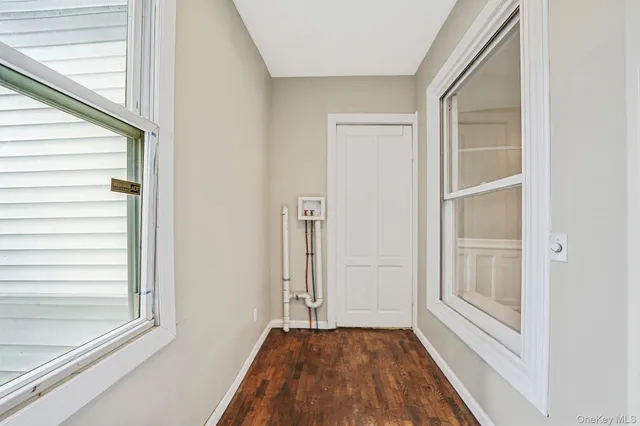 a view of a hallway with closet and window