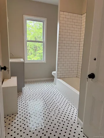 a bathroom with a bathtub and shower