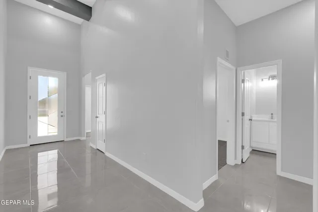 a view of hallway with closet and cabinet