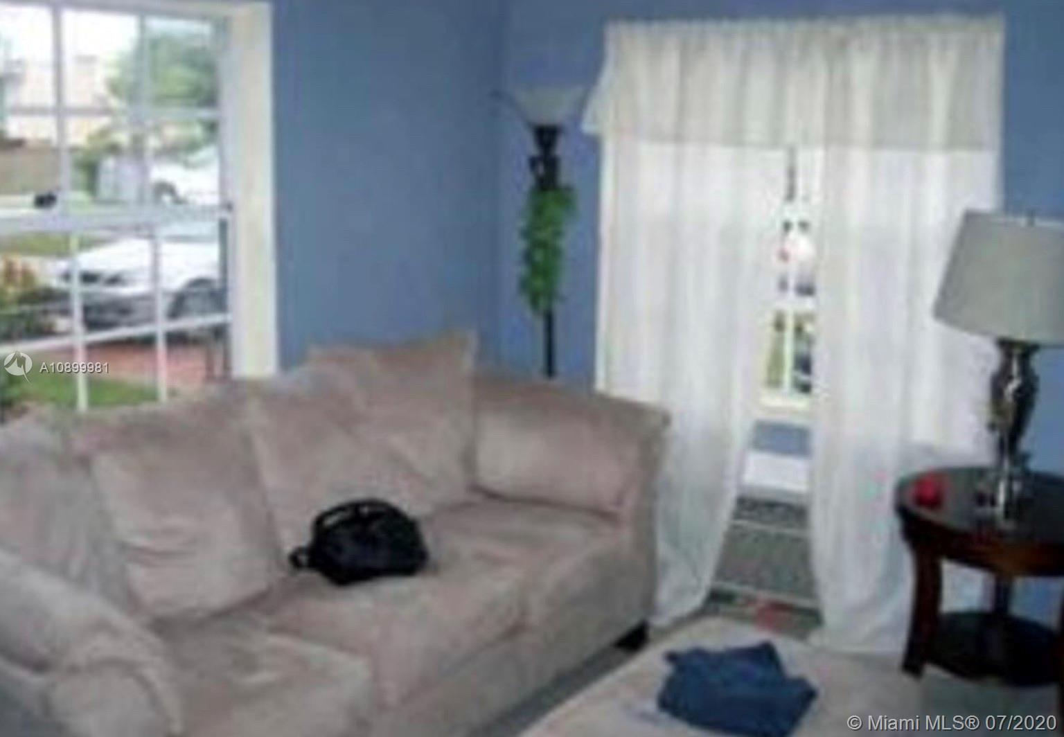 3431 Southwest 16th Terrace Miami, FL 33145 - Photo 2 of 3 a living room with furniture and a window