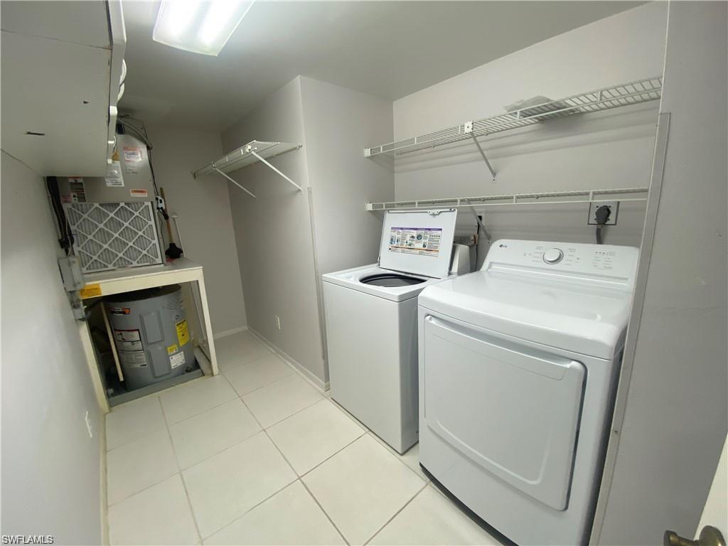 705 Augusta Boulevard, Unit 7055 Naples, FL 34113 - Photo 13 of 18 a utility room with dryer and washer