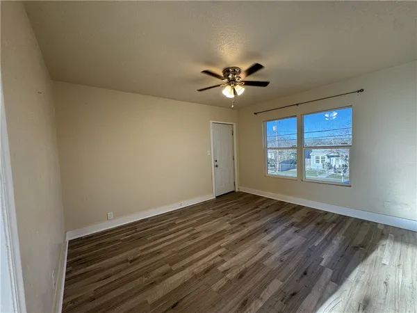 wooden floor in an empty room with a window