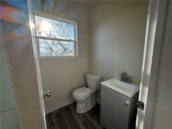 a bathroom with a toilet sink and window
