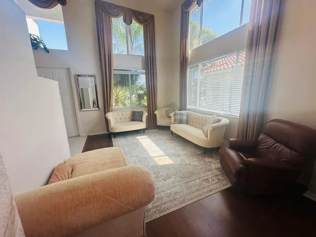a living room with furniture and a large window