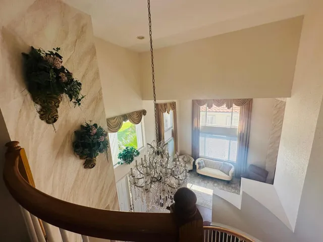 a living room with furniture and a floor to ceiling window