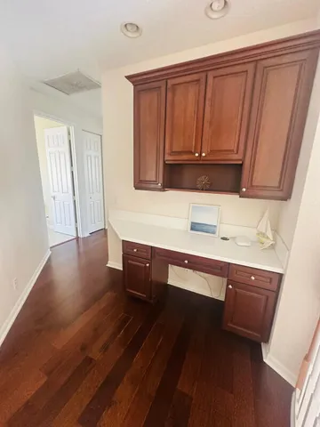 a kitchen with wooden floors and wooden cabinets