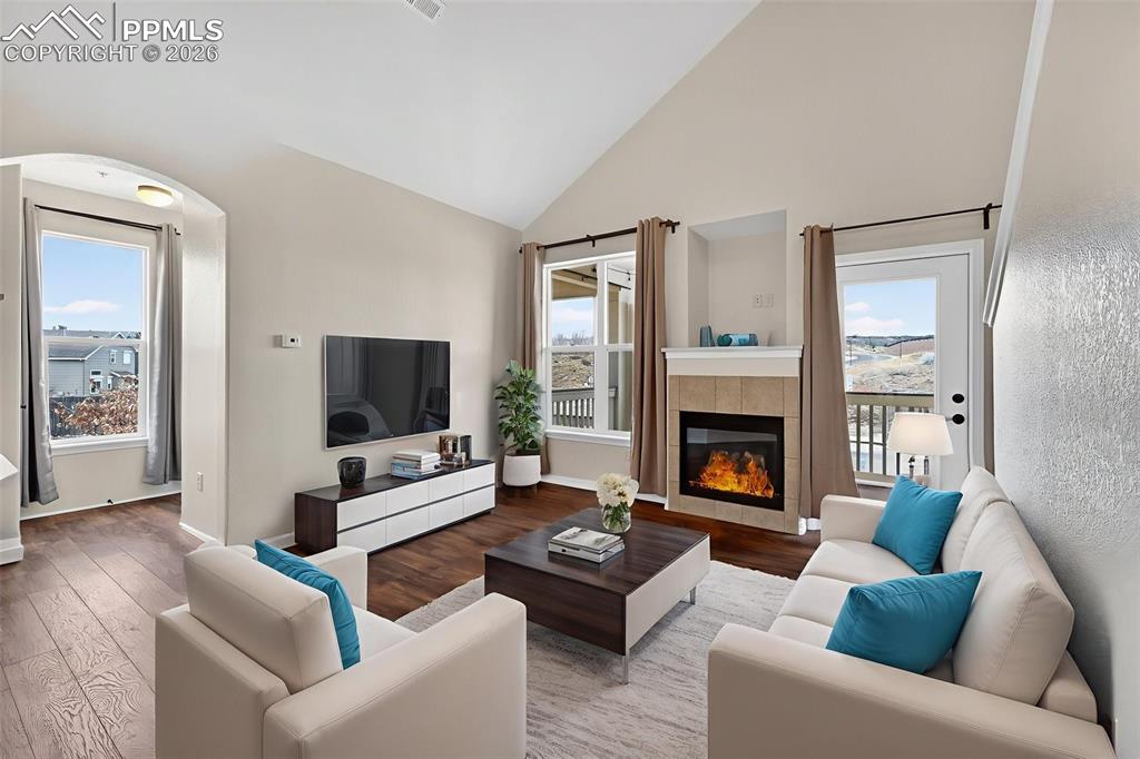 5378 Palomino Ranch Point, Unit 208 Colorado Springs, CO 80922 - Photo 15 of 38 a living room with furniture flat screen tv and a fireplace