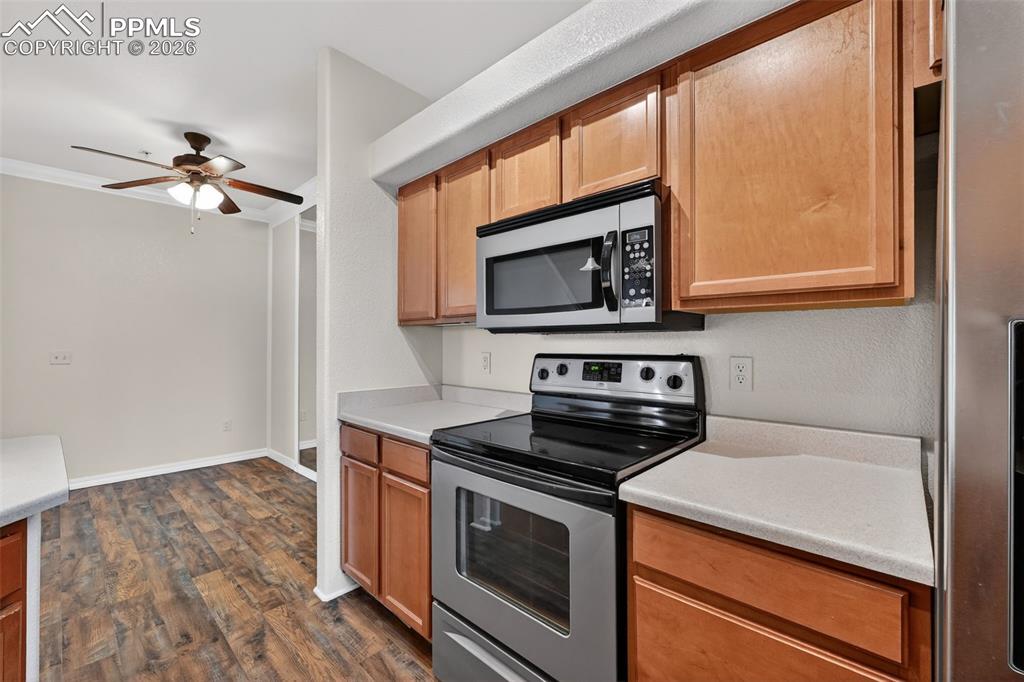 5378 Palomino Ranch Point, Unit 208 Colorado Springs, CO 80922 - Photo 22 of 38 a kitchen with a stove microwave and a sink
