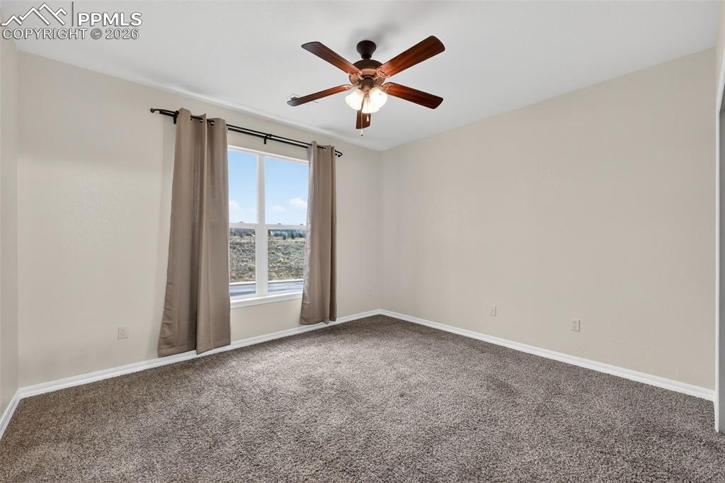 5378 Palomino Ranch Point, Unit 208 Colorado Springs, CO 80922 - Photo 24 of 38 an empty room with ceiling fan and window