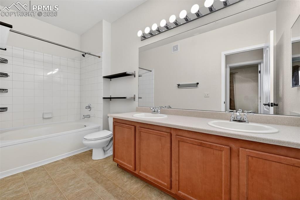 5378 Palomino Ranch Point, Unit 208 Colorado Springs, CO 80922 - Photo 26 of 38 a bathroom with a sink a toilet and shower