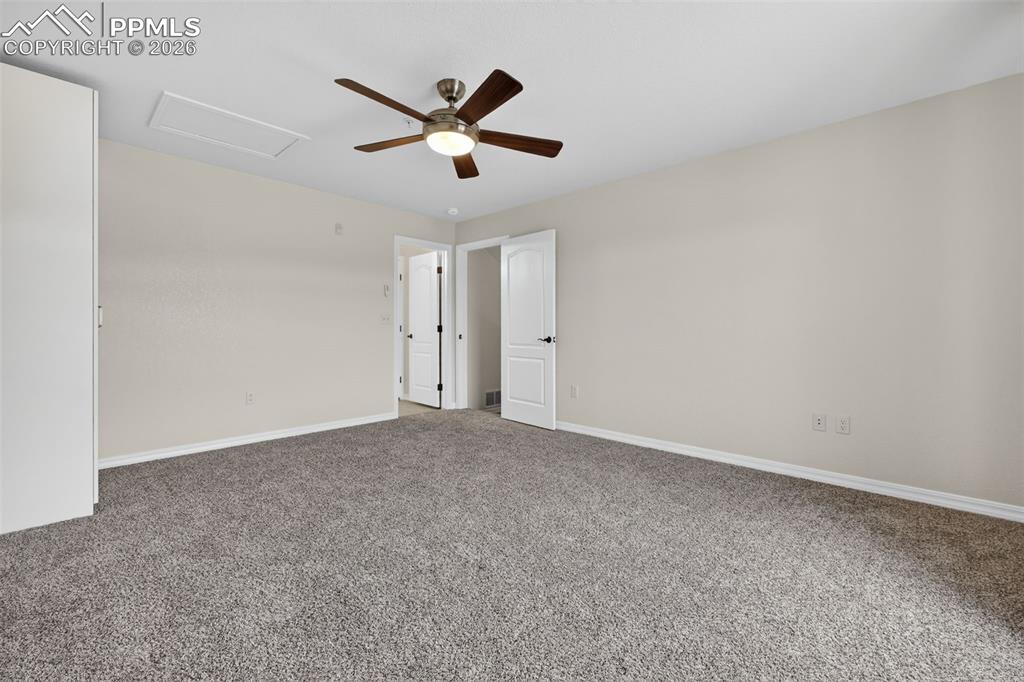 5378 Palomino Ranch Point, Unit 208 Colorado Springs, CO 80922 - Photo 30 of 38 an empty room with a ceiling fan and window