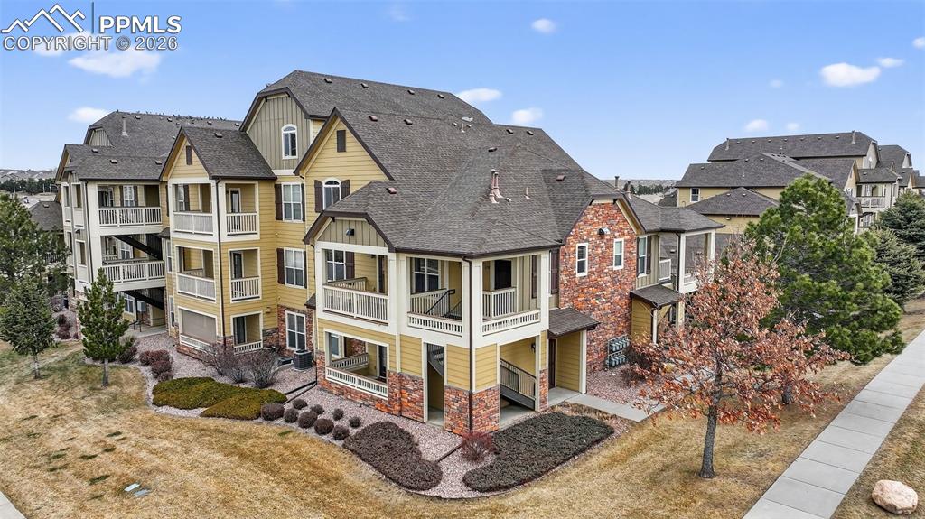 5378 Palomino Ranch Point, Unit 208 Colorado Springs, CO 80922 - Photo 3 of 38 a view of a white house with large windows next to a road