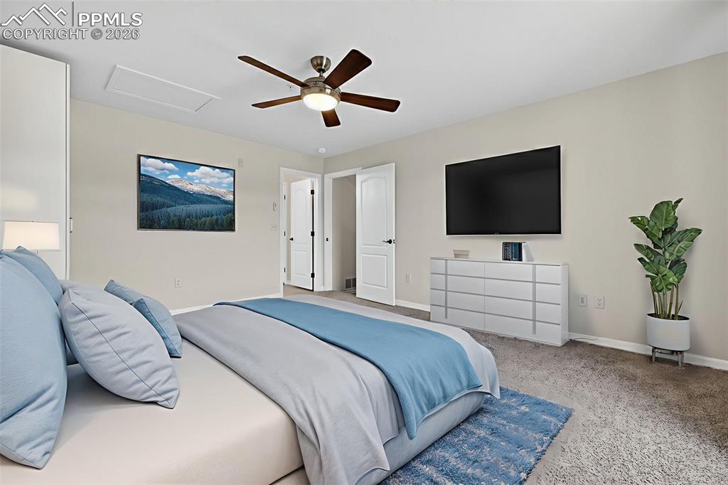 5378 Palomino Ranch Point, Unit 208 Colorado Springs, CO 80922 - Photo 31 of 38 a bedroom with a bed and a flat screen tv