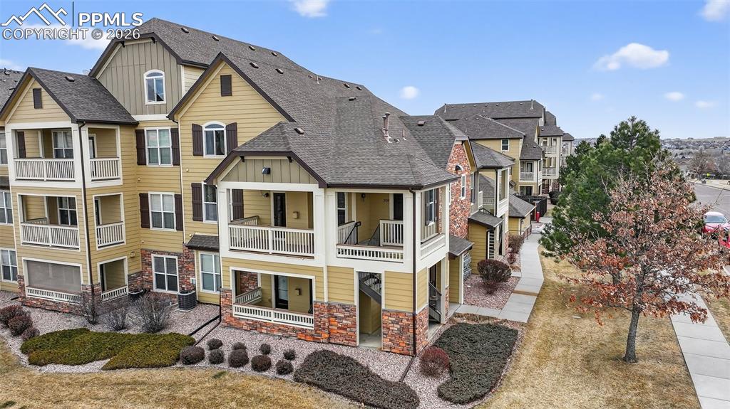 5378 Palomino Ranch Point, Unit 208 Colorado Springs, CO 80922 - Photo 6 of 38 a front view of a house with a yard