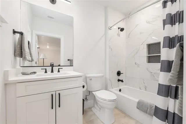 a kitchen with kitchen island a large counter top space a sink stainless steel appliances and cabinets