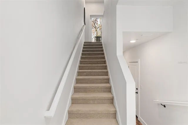 a view of a a dining room with furniture window and wooden floor