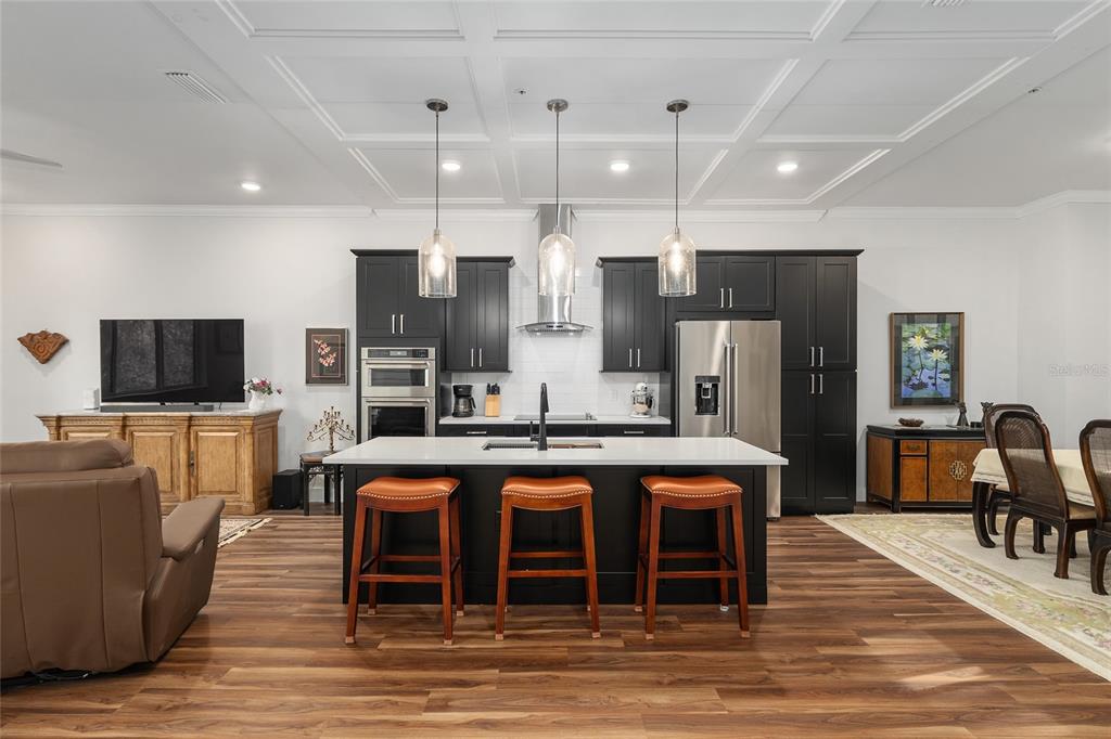2601 Southwest Williston Road, Unit 106 Gainesville, FL 32608 - Photo 20 of 82 a kitchen with stainless steel appliances granite countertop a sink and a refrigerator