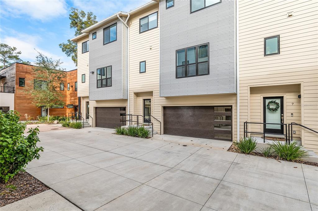 2601 Southwest Williston Road, Unit 106 Gainesville, FL 32608 - Photo 2 of 82 a front view of a house with yard and parking