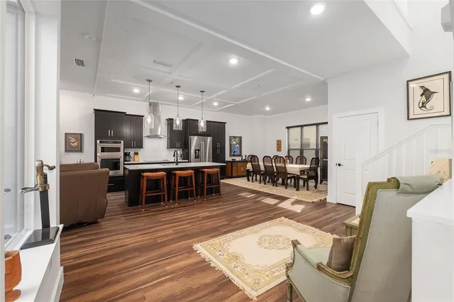 a living room with furniture kitchen view and a table