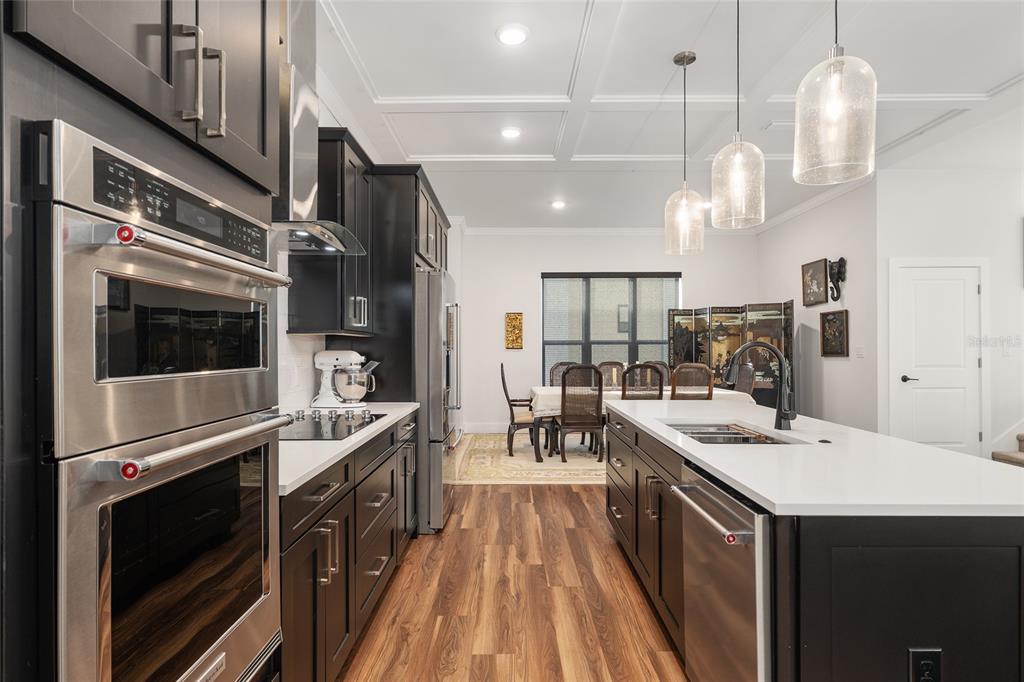 2601 Southwest Williston Road, Unit 106 Gainesville, FL 32608 - Photo 31 of 82 a kitchen with kitchen island a large counter top space a sink stainless steel appliances and cabinets