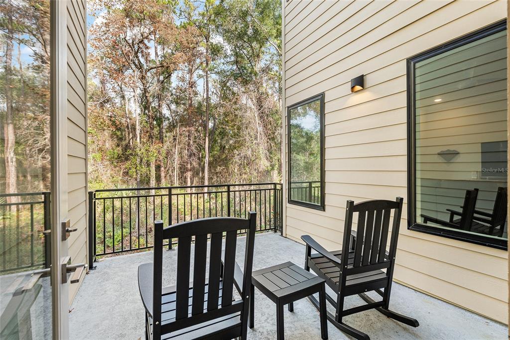 2601 Southwest Williston Road, Unit 106 Gainesville, FL 32608 - Photo 45 of 82 a view of balcony with wooden floor and outdoor seating