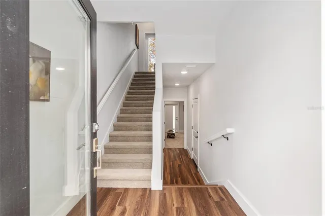 a bathroom with a sink a toilet a mirror and shower curtain