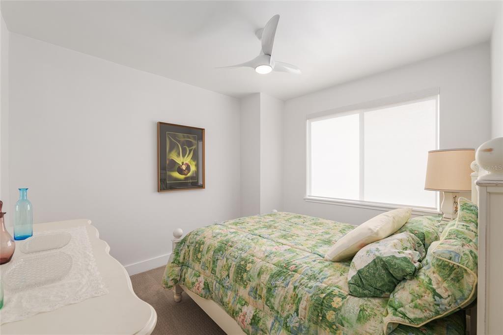 2601 Southwest Williston Road, Unit 106 Gainesville, FL 32608 - Photo 63 of 82 a bedroom with a bed and a lamp