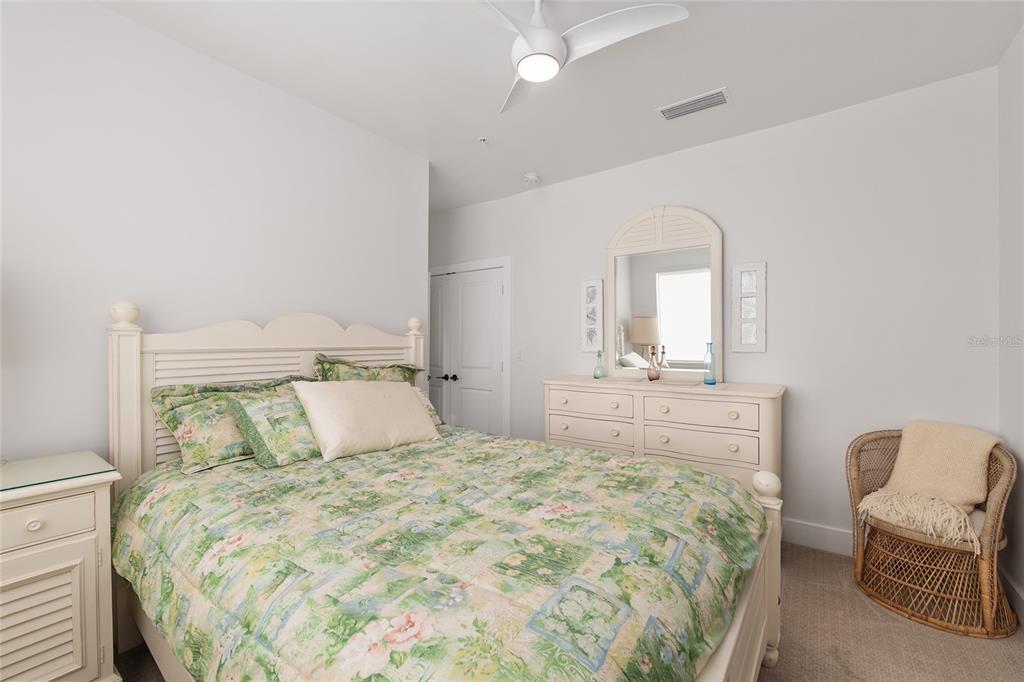 2601 Southwest Williston Road, Unit 106 Gainesville, FL 32608 - Photo 64 of 82 a bedroom with a bed and chair