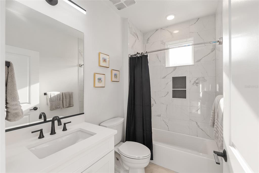 2601 Southwest Williston Road, Unit 106 Gainesville, FL 32608 - Photo 66 of 82 a bathroom with a sink a toilet and shower