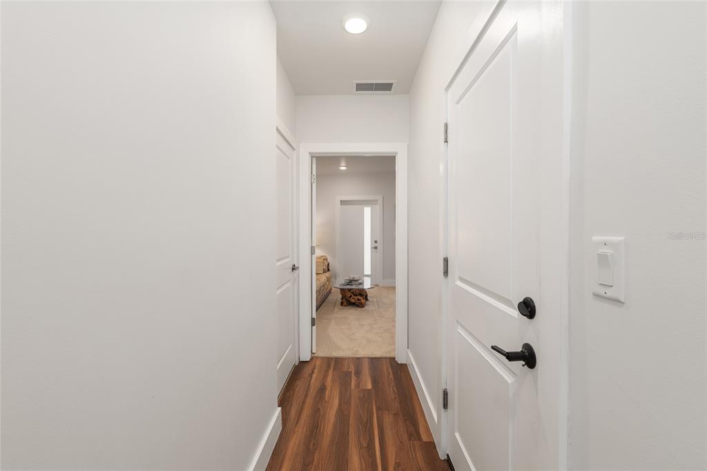 2601 Southwest Williston Road, Unit 106 Gainesville, FL 32608 - Photo 69 of 82 a view of a hallway with wooden floor and closet