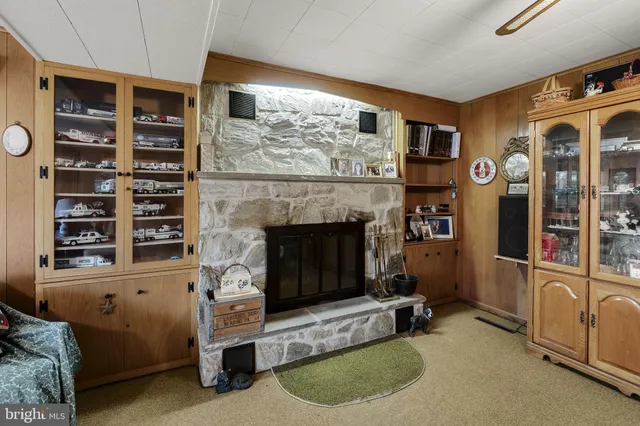 a bathroom with a granite countertop sink a mirror and a shower