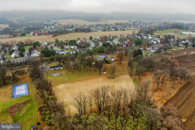 a front view of a house with a yard and outdoor seating