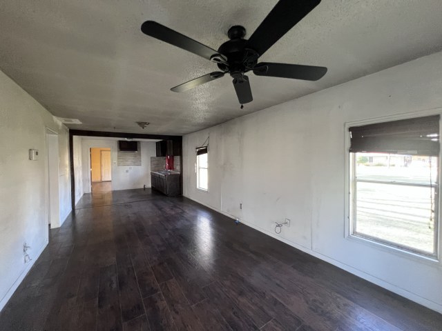507 Natchez Street Hearne, TX 77859 - Photo 5 of 12 wooden floor in an empty room with a window