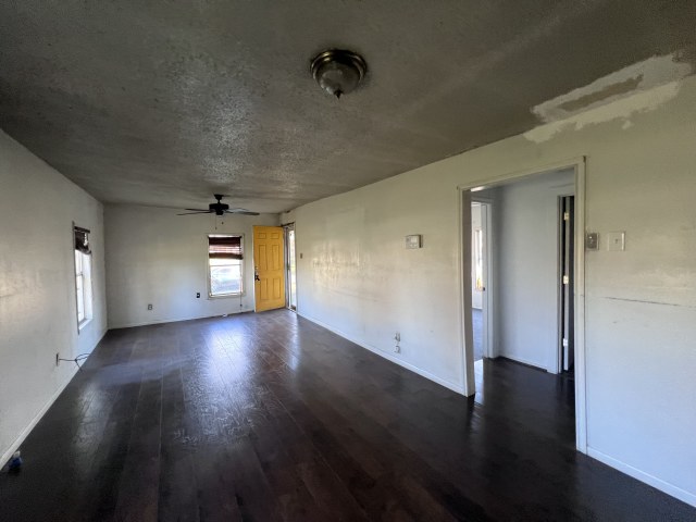 507 Natchez Street Hearne, TX 77859 - Photo 6 of 12 an empty room with wooden floor and windows
