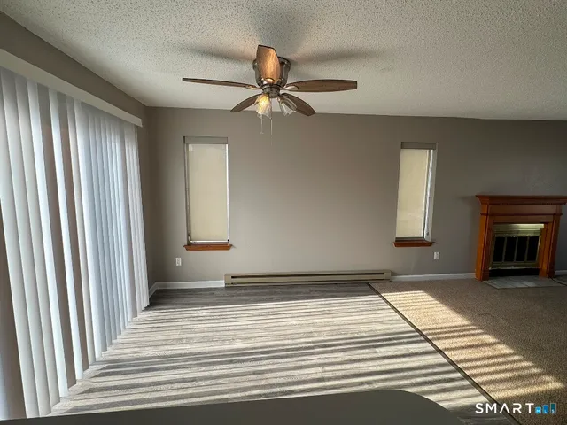 a view of a livingroom with an empty space and a fireplace