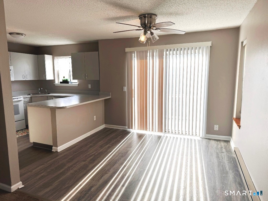 925 Oronoke Road, Unit 30L Waterbury, CT 06708 - Photo 4 of 21 a view of a kitchen with wooden floor and a sink