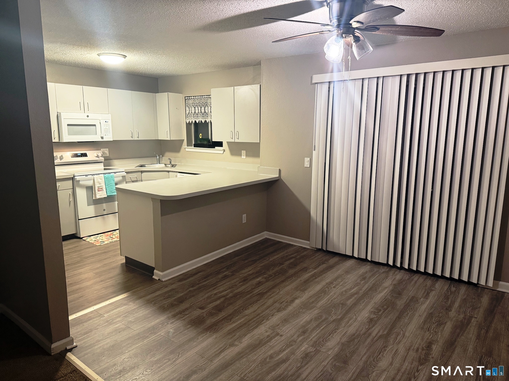 925 Oronoke Road, Unit 30L Waterbury, CT 06708 - Photo 5 of 21 a view with kitchen island wooden floor