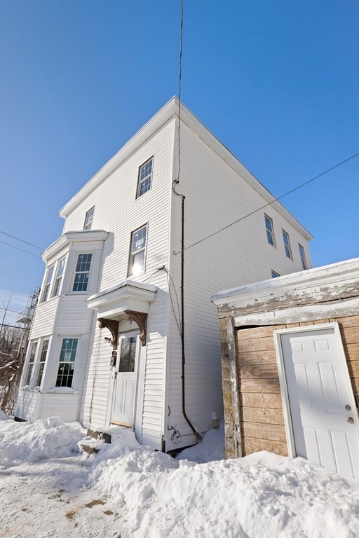 5 Temple Street Lawrence, MA 01843 - Photo 2 of 17 a view of a house with a house in the background