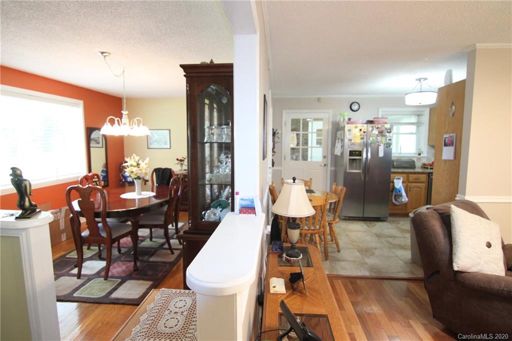 517 Loray Farm Road Dallas, NC 28034 - Photo 22 of 48 a dining room with furniture a rug and wooden floor