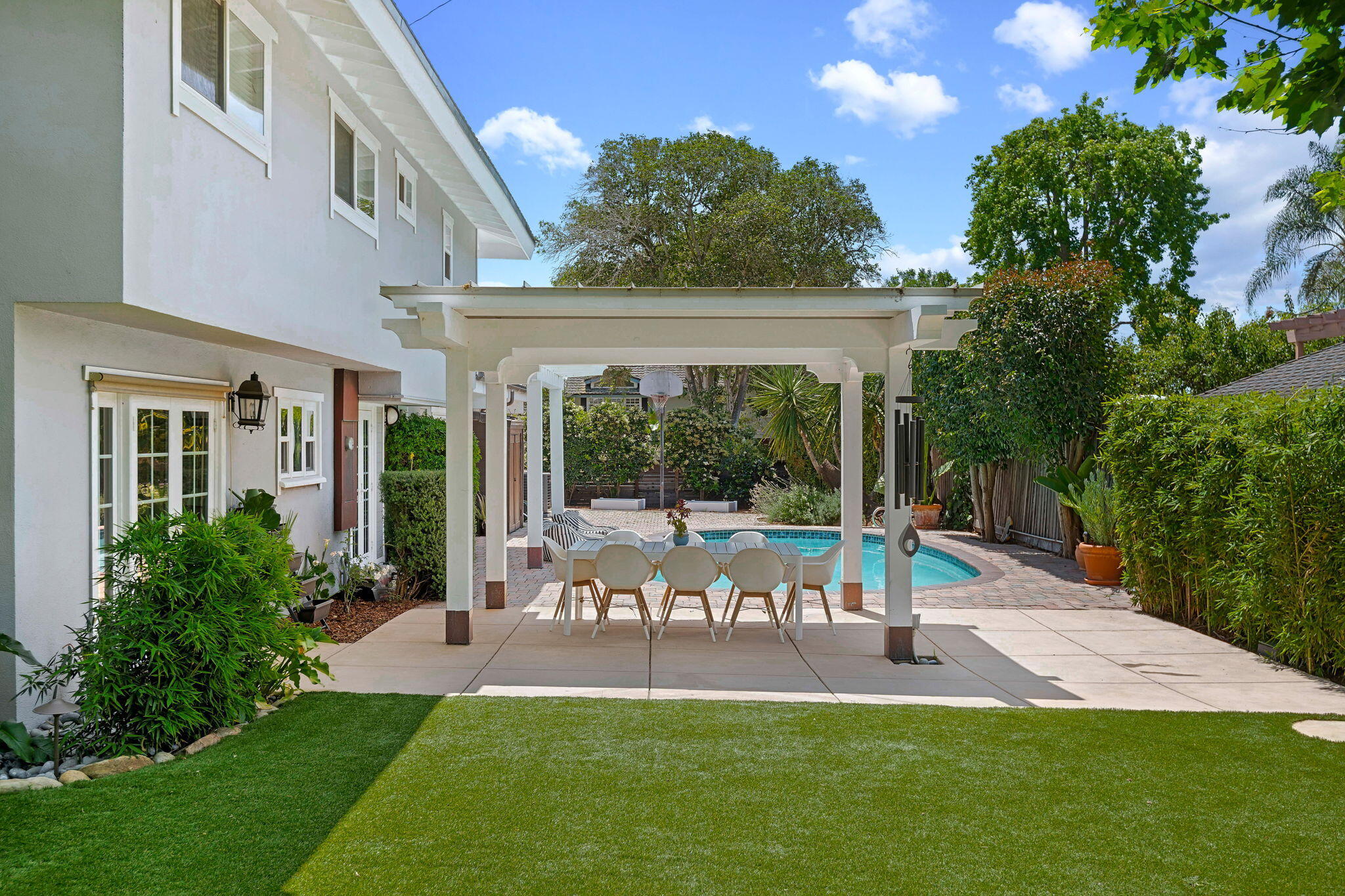 809 Willowglen Road Santa Barbara, CA 93105 - Photo 22 of 50 a view of a patio with table and chairs potted plants and large tree