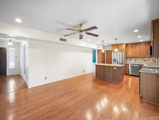 a view of a kitchen with a sink and a refrigerator